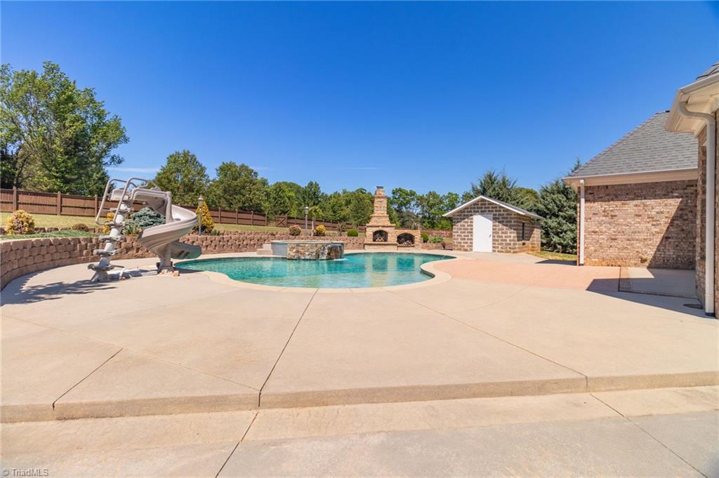 8204 Brotherstwo Road Colfax, NC 27235 - Photo 45 of 50 Expansive concrete area with underground drainaige surrounding pool