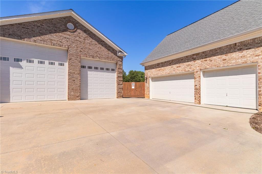 8204 Brotherstwo Road Colfax, NC 27235 - Photo 6 of 50 Attached 3 car garage and 30x60 all brick building with 16' ceilings