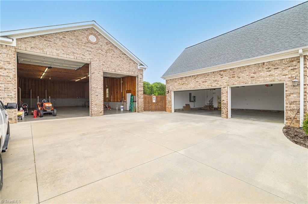 8204 Brotherstwo Road Colfax, NC 27235 - Photo 7 of 50 Detached garage has 12' and 14' insulated doors allowing a variety of vehicle options