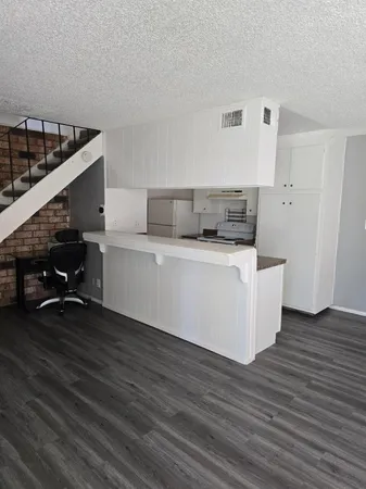 a view of kitchen with furniture and wooden floor