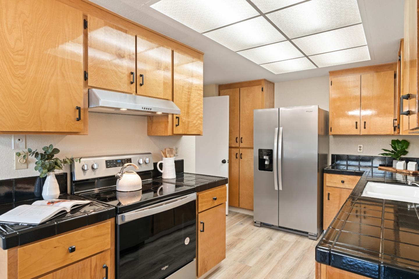 818 Coyote Road San Jose, CA 95111 - Photo 7 of 39 a kitchen with stainless steel appliances a refrigerator sink and cabinets