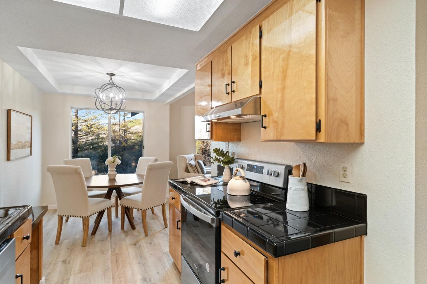 818 Coyote Road San Jose, CA 95111 - Photo 10 of 39 a kitchen with stainless steel appliances granite countertop a stove top oven a sink dishwasher and white cabinets with wooden floor