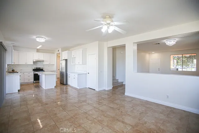 a view of a kitchen with wooden floor and chandelier