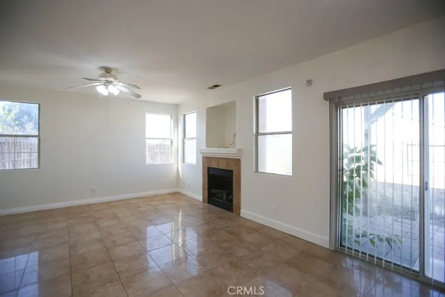a view of a livingroom with a ceiling fan and window