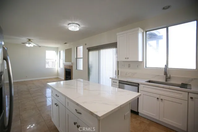 a bathroom with a granite countertop sink and a window