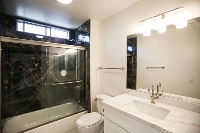 a bathroom with a shower sink and mirror