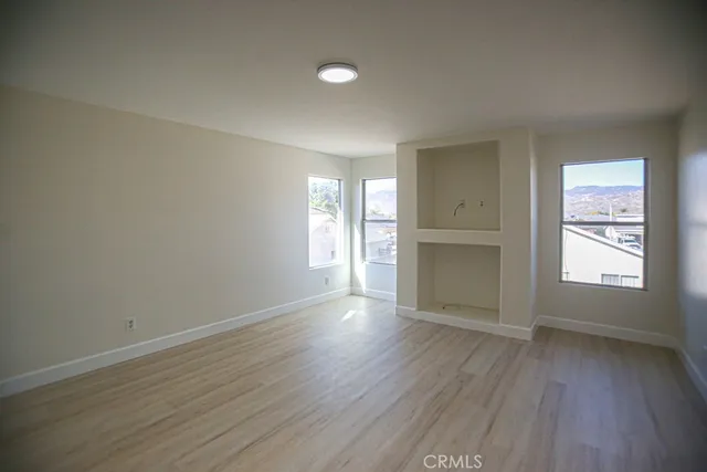 wooden floor in an empty room with a window