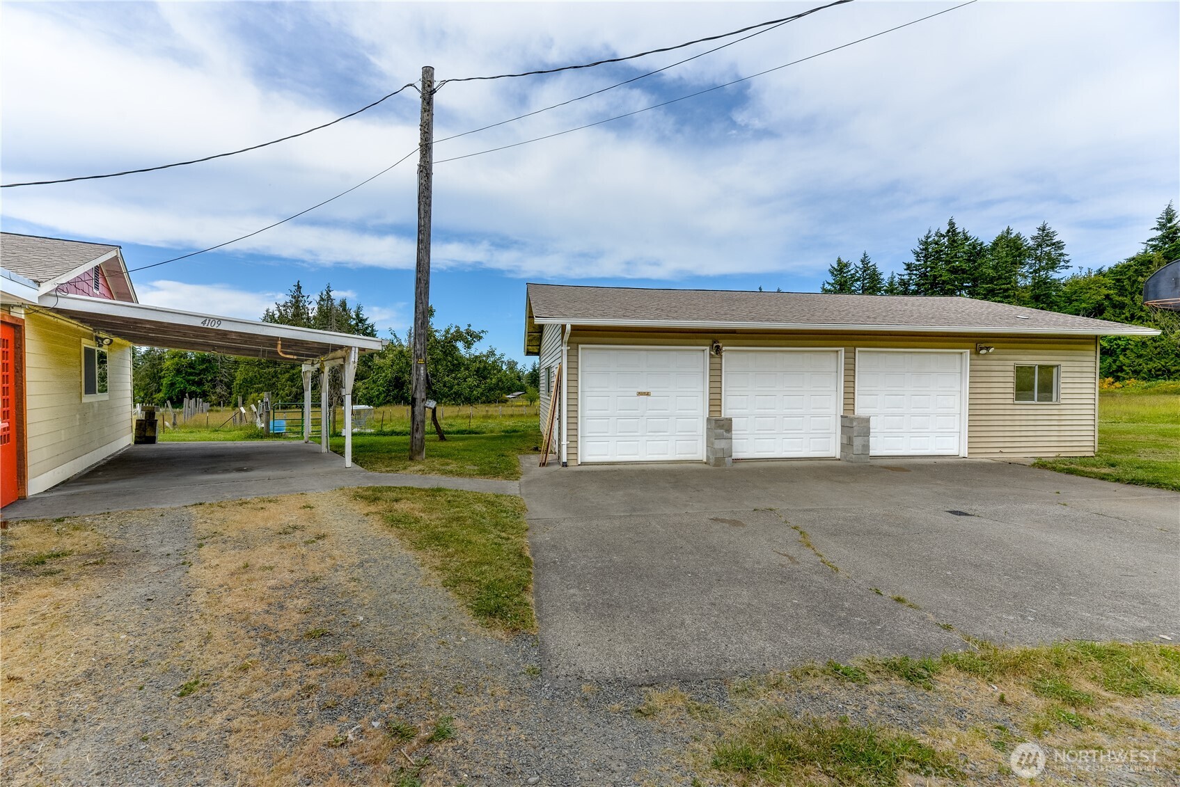 4109 South Reddick Road Port Angeles, WA 98363 - Photo 27 of 38 a view of a house with a backyard and garage