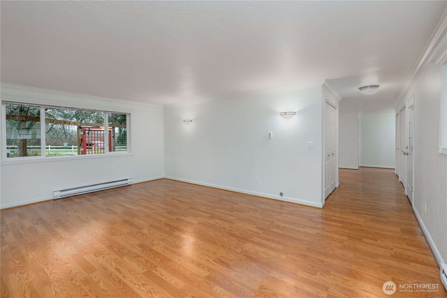4109 South Reddick Road Port Angeles, WA 98363 - Photo 3 of 38 a view of an empty room with wooden floor and a window