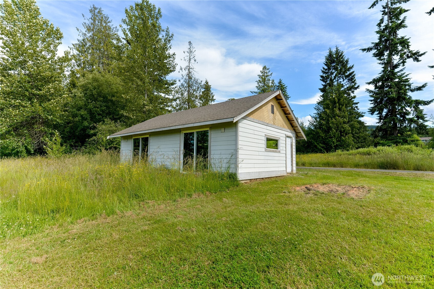 4109 South Reddick Road Port Angeles, WA 98363 - Photo 31 of 38 a view of a backyard with plants and large trees