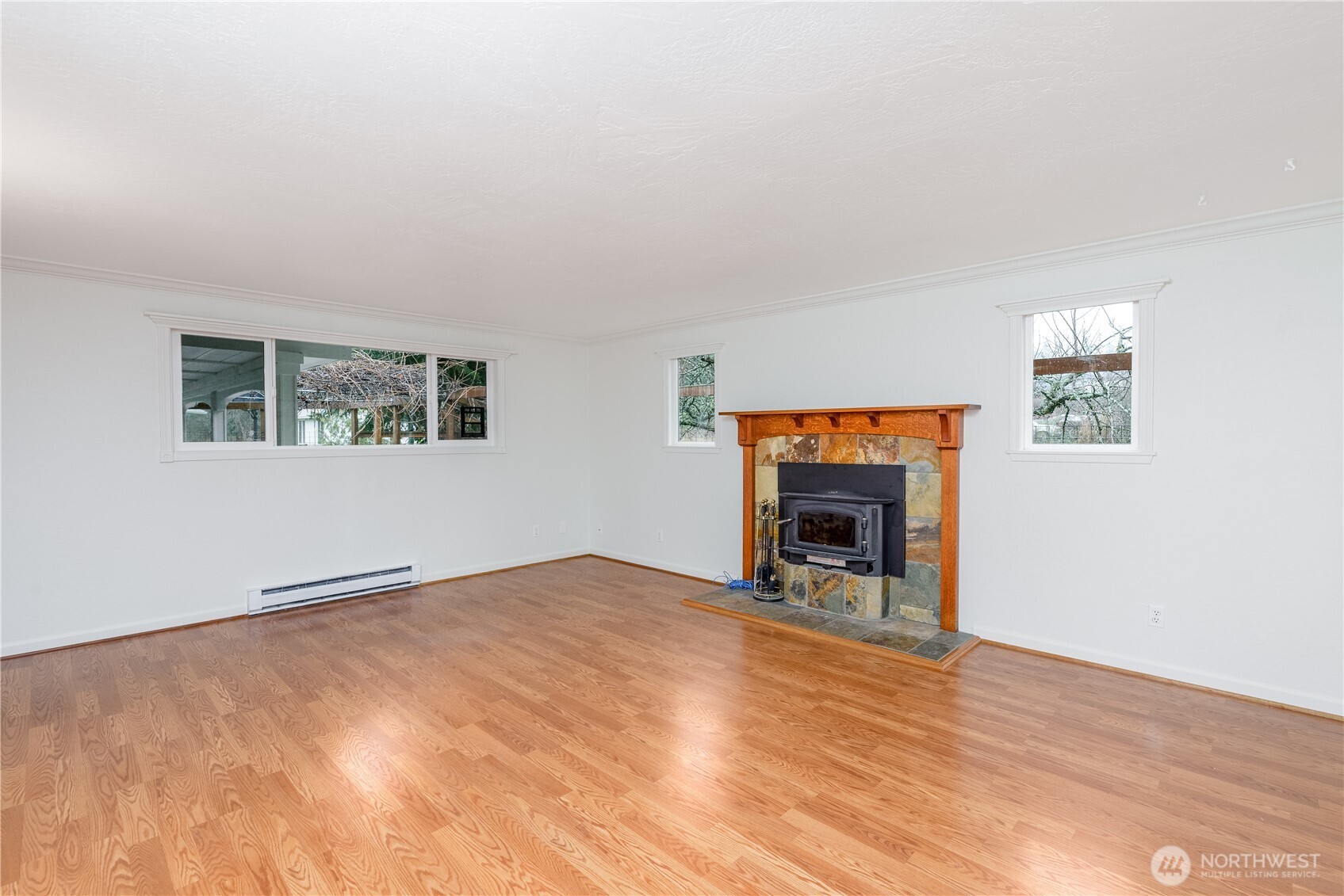 4109 South Reddick Road Port Angeles, WA 98363 - Photo 5 of 38 a view of an empty room with a window and fireplace