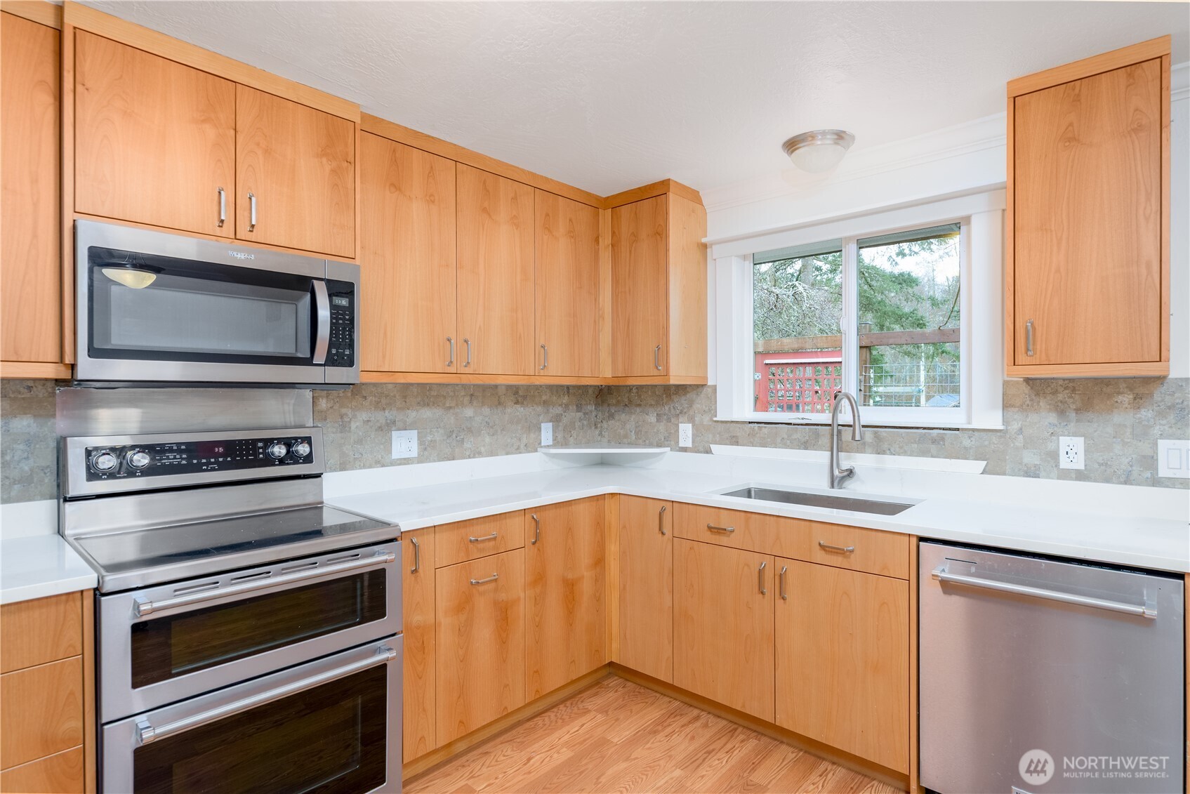 4109 South Reddick Road Port Angeles, WA 98363 - Photo 8 of 38 a kitchen with a sink stove and microwave