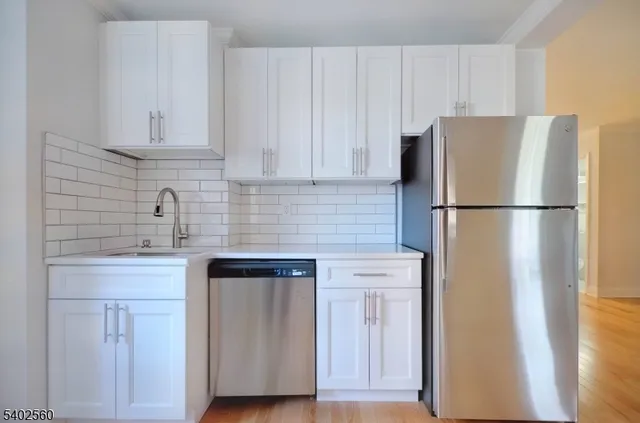 a white refrigerator freezer sitting inside of a kitchen