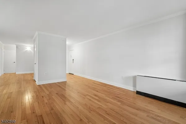 a view of an empty room and wooden floor