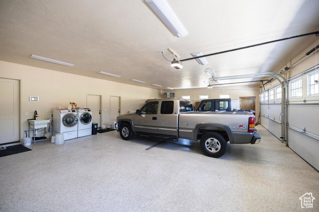 6117 North Rocky Ridge Road Peoa, UT 84061 - Photo 10 of 83 Garage with a garage door opener and washing machine and clothes dryer
