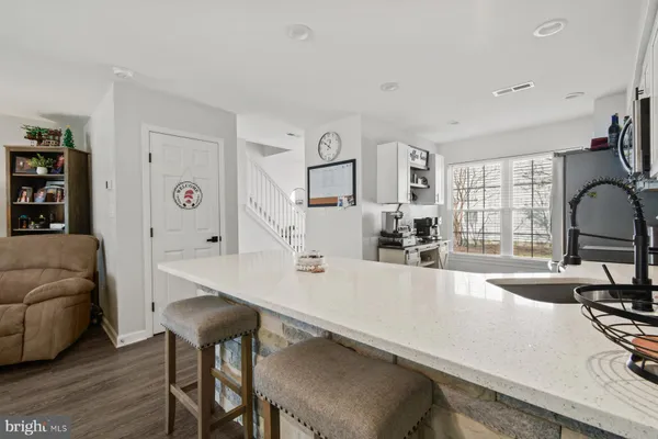 a large white kitchen with a large window