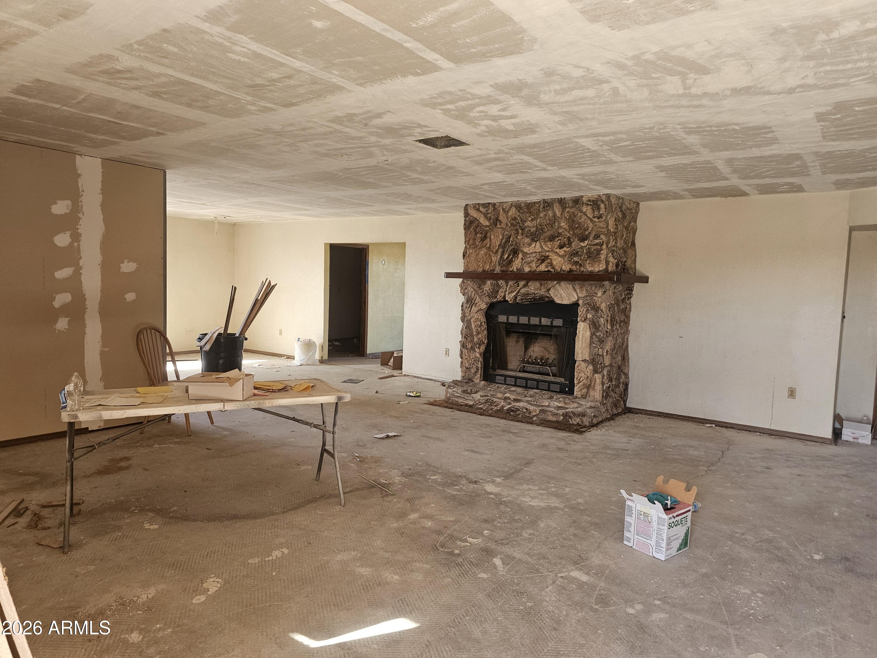 3613 North Papoose Road, Unit 3613 Casa Grande, AZ 85193 - Photo 11 of 19 a living room with patio furniture and a fireplace