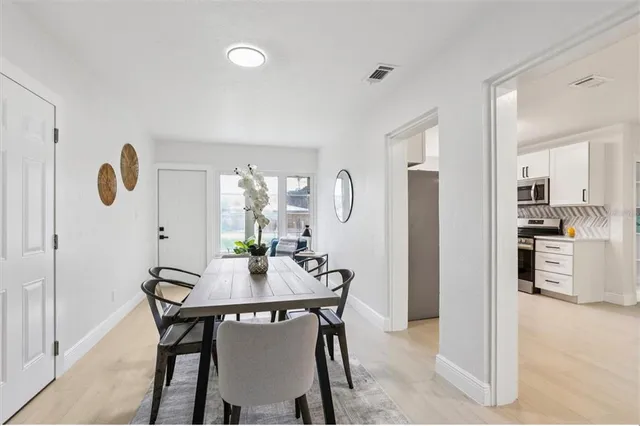 a view of a dining room with furniture and wooden floor