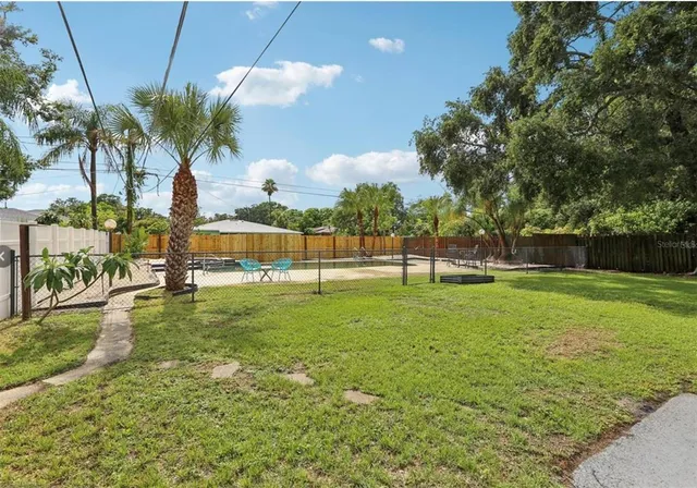 a view of yard with swimming pool