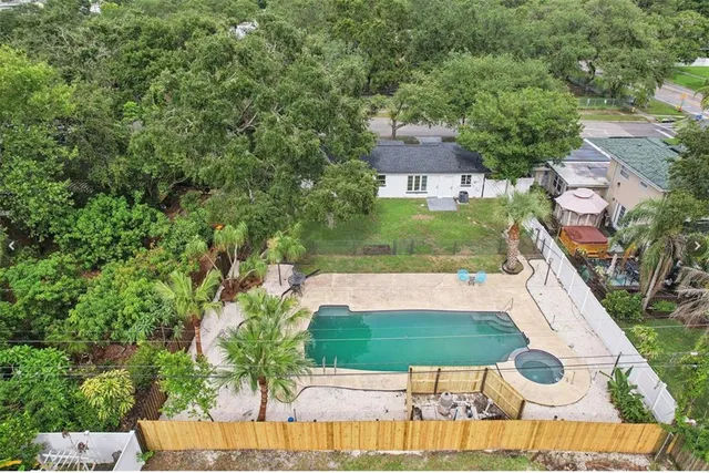 an aerial view of a house with yard swimming pool and outdoor seating