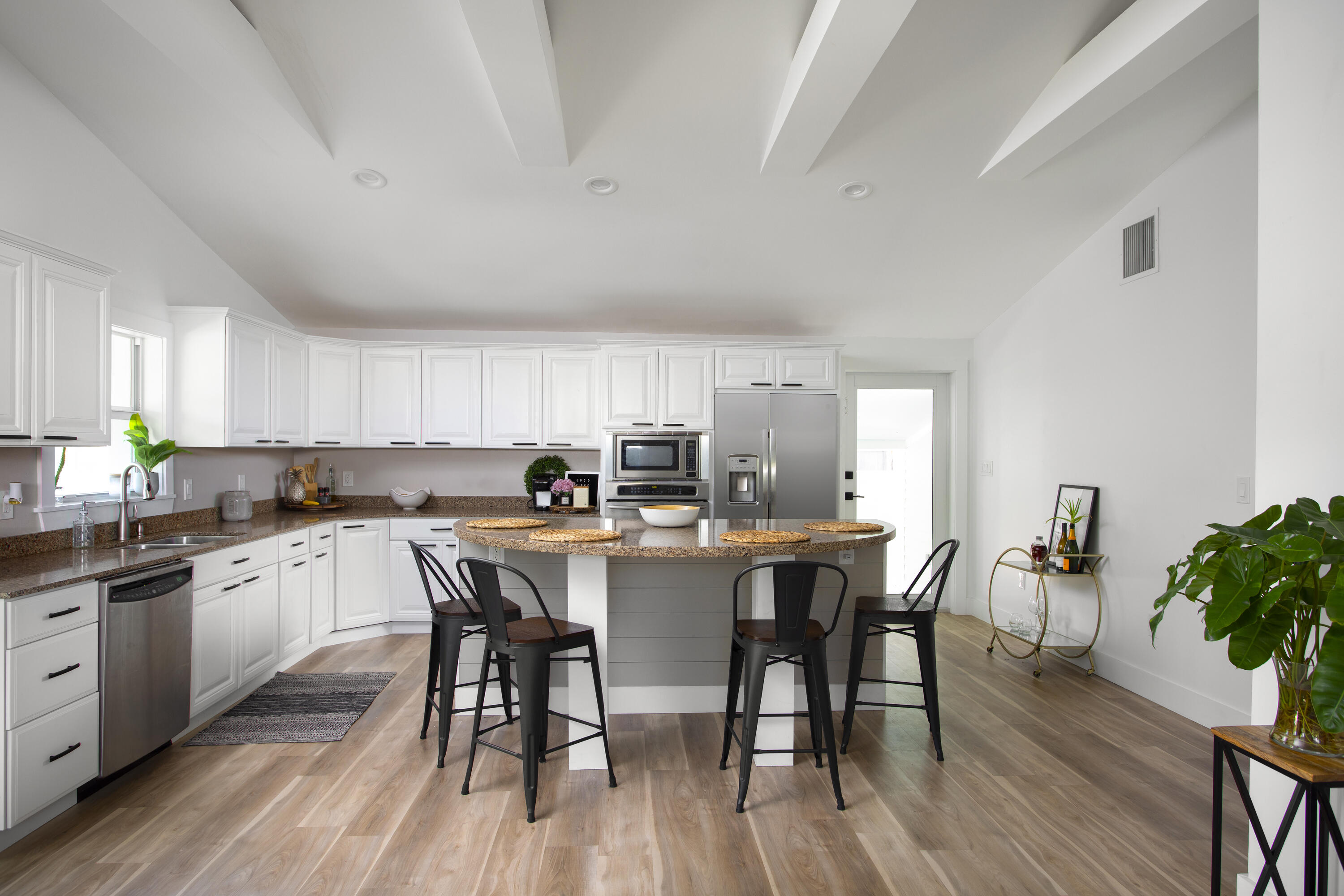 1522 Washington Street Key West, FL 33040 - Photo 5 of 21 a kitchen with stainless steel appliances a table chairs refrigerator and sink