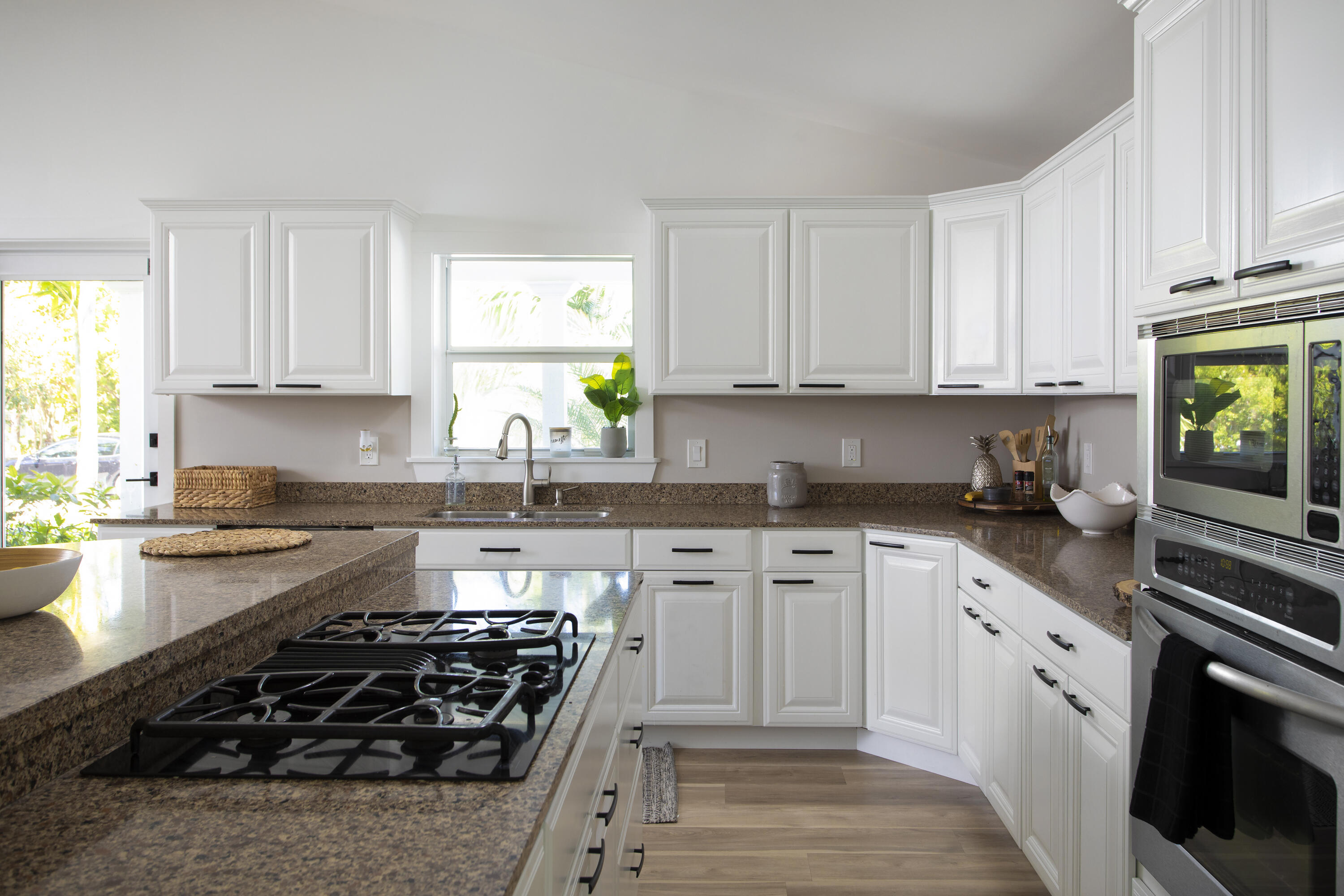 1522 Washington Street Key West, FL 33040 - Photo 6 of 21 a kitchen with stainless steel appliances a stove a sink cabinets and a window