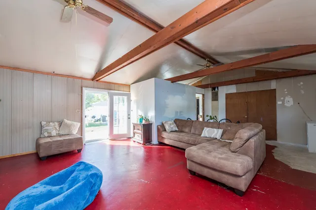 a view of a house with a big yard and a large tree
