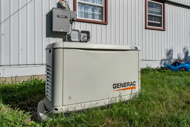 a view of backyard with barbeque grill and wooden fence