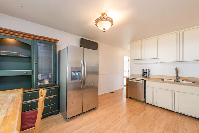 a kitchen with stainless steel appliances granite countertop a refrigerator and a stove top oven