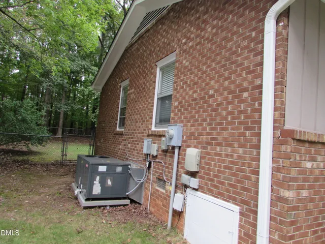 a view of backyard with brick wall and outdoor seating