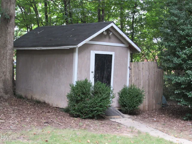 a front view of house with yard and trees