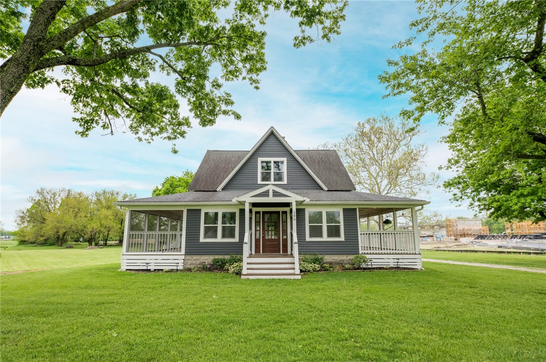 190 Swailes Road Troy, OH 45373 - Photo 2 of 82 This charming home offers a welcoming facade with a lush green yard and inviting porch.