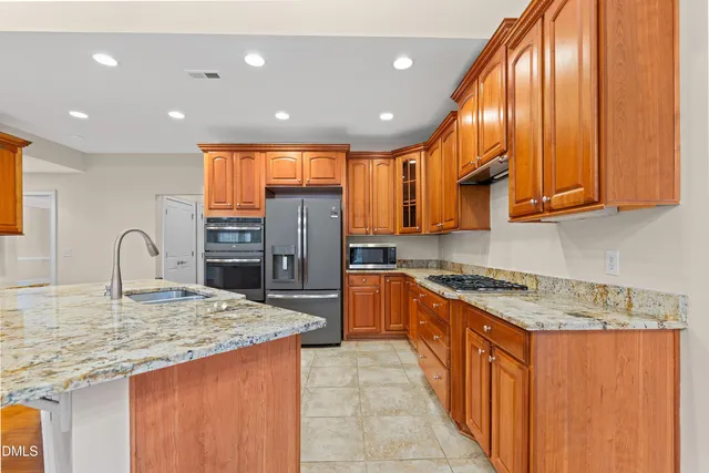 a bathroom with a granite countertop double vanity sink mirror and