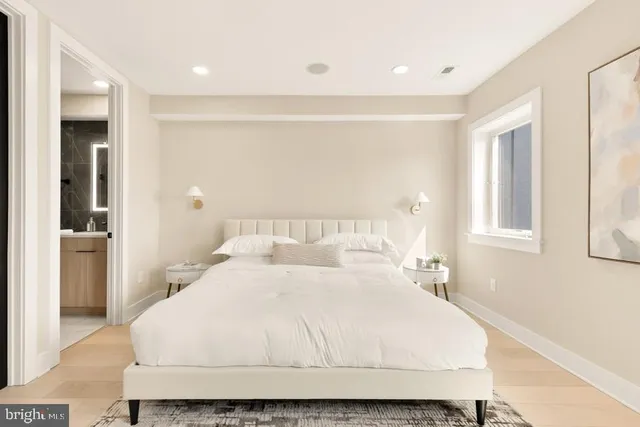 a large white bed in a white room