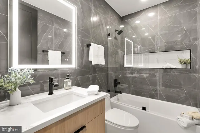 a bathroom with a sink a toilet and bathtub