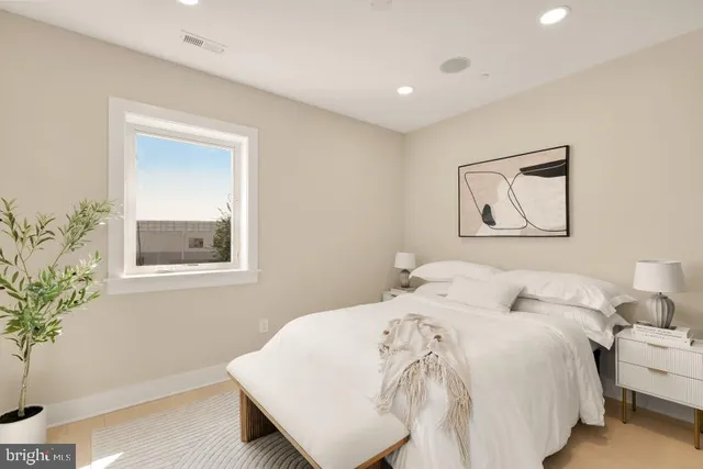 a bedroom with a bed and a painting on the wall