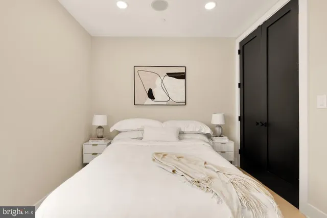 a bedroom with a bed and a painting on the wall