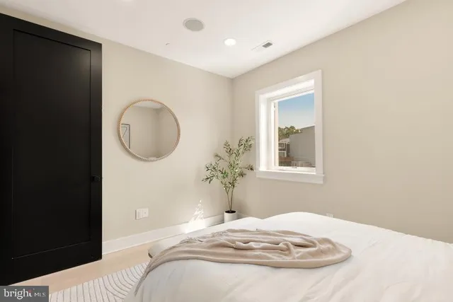 a bedroom with a bed and a window