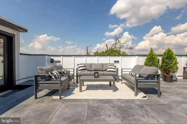 a view of a terrace with dining table and chairs