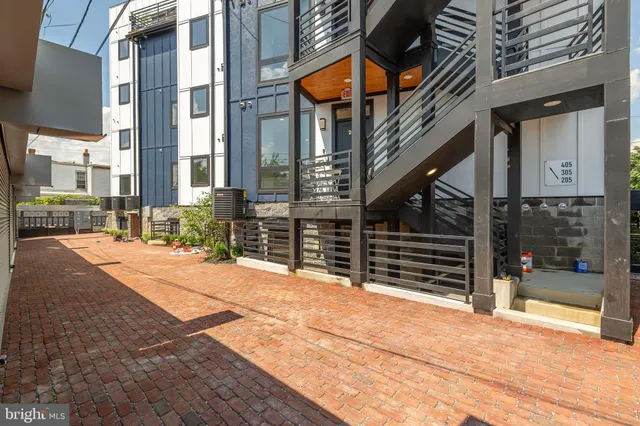 a view of backyard with brick wall and seating space