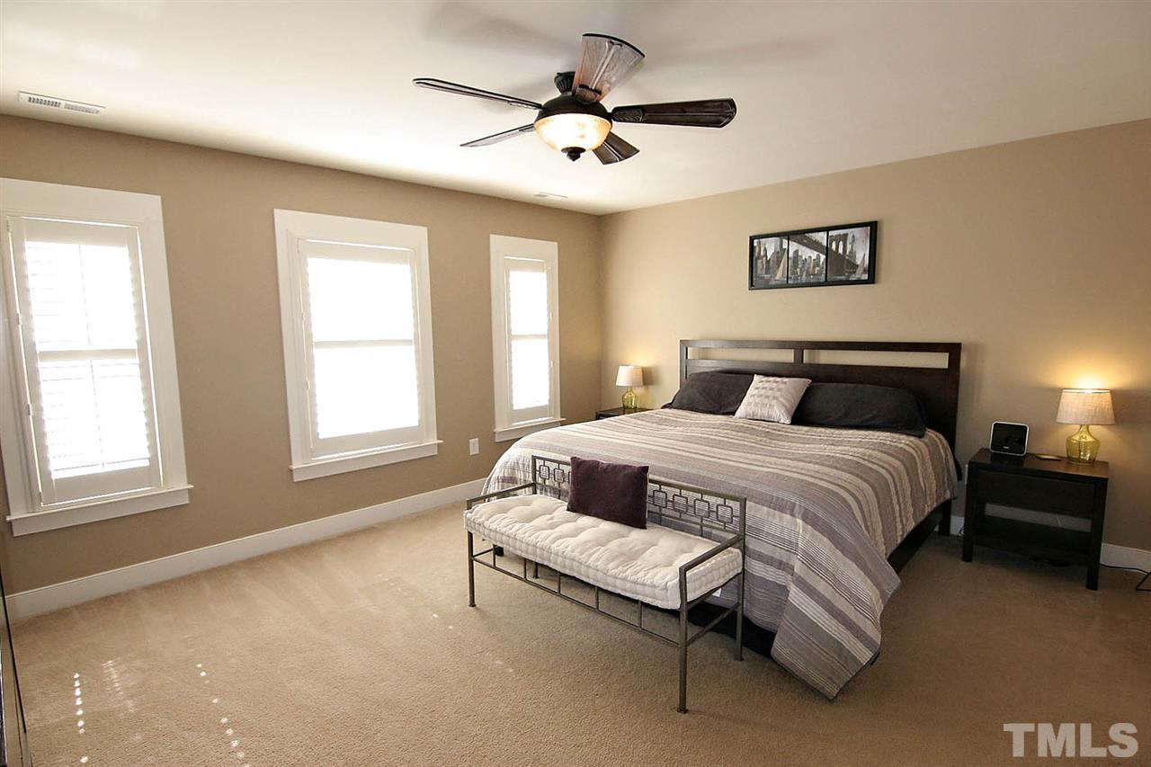 2248 Dunlin Lane Raleigh, NC 27614 - Photo 11 of 24 a spacious bedroom with a bed and a ceiling fan