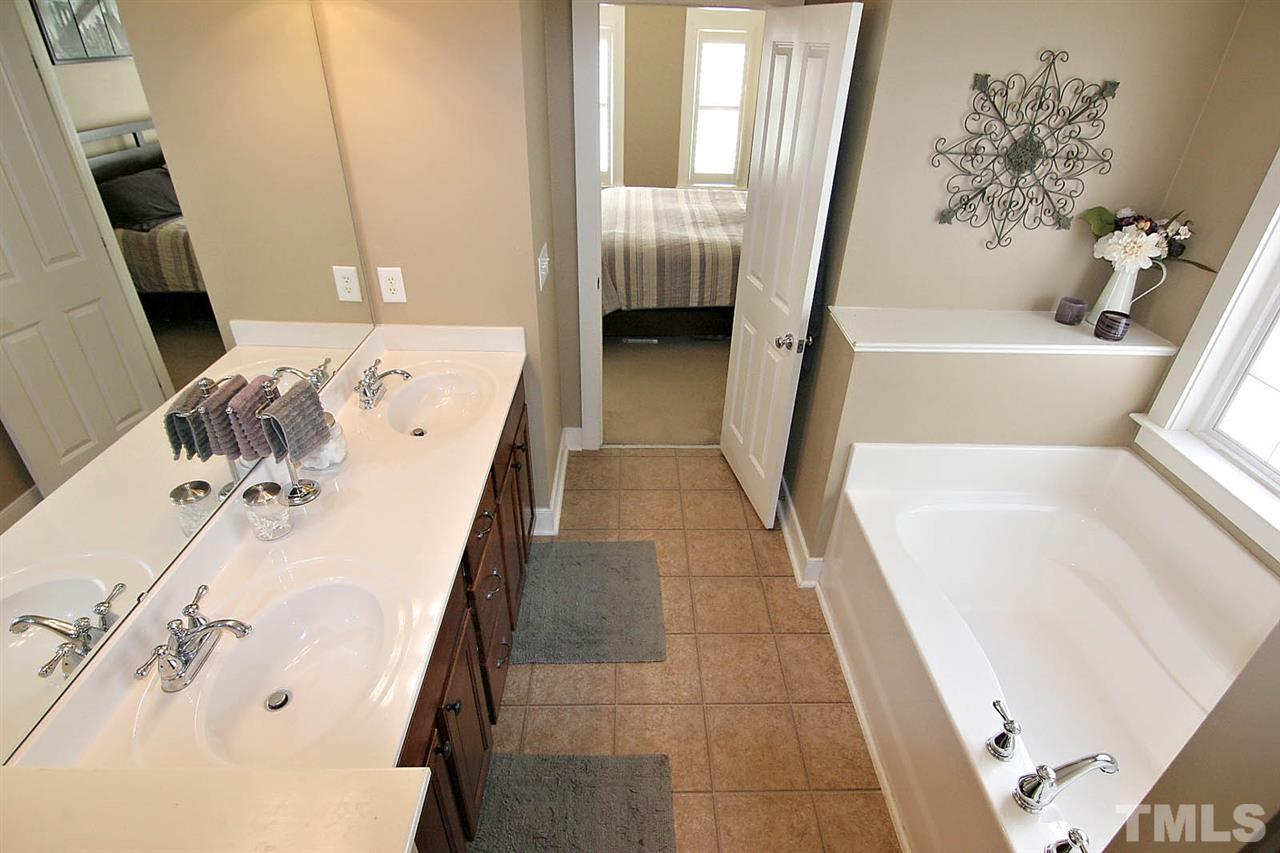 2248 Dunlin Lane Raleigh, NC 27614 - Photo 14 of 24 a bathroom with a tub sink and mirror