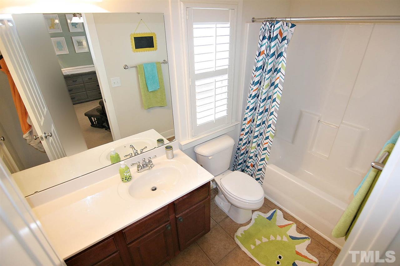 2248 Dunlin Lane Raleigh, NC 27614 - Photo 16 of 24 a bathroom with a sink a toilet and shower curtain