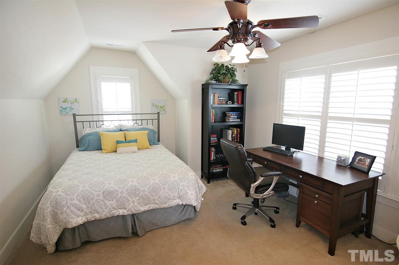 2248 Dunlin Lane Raleigh, NC 27614 - Photo 17 of 24 a bedroom with a bed and a chandelier