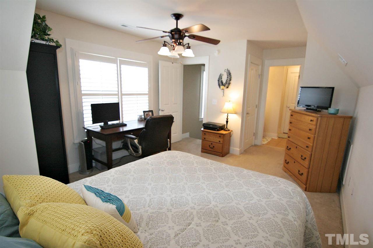 2248 Dunlin Lane Raleigh, NC 27614 - Photo 18 of 24 a bedroom with a bed furniture and a flat tv screen