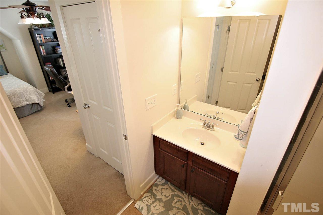 2248 Dunlin Lane Raleigh, NC 27614 - Photo 19 of 24 a bathroom with a sink a mirror and a shower