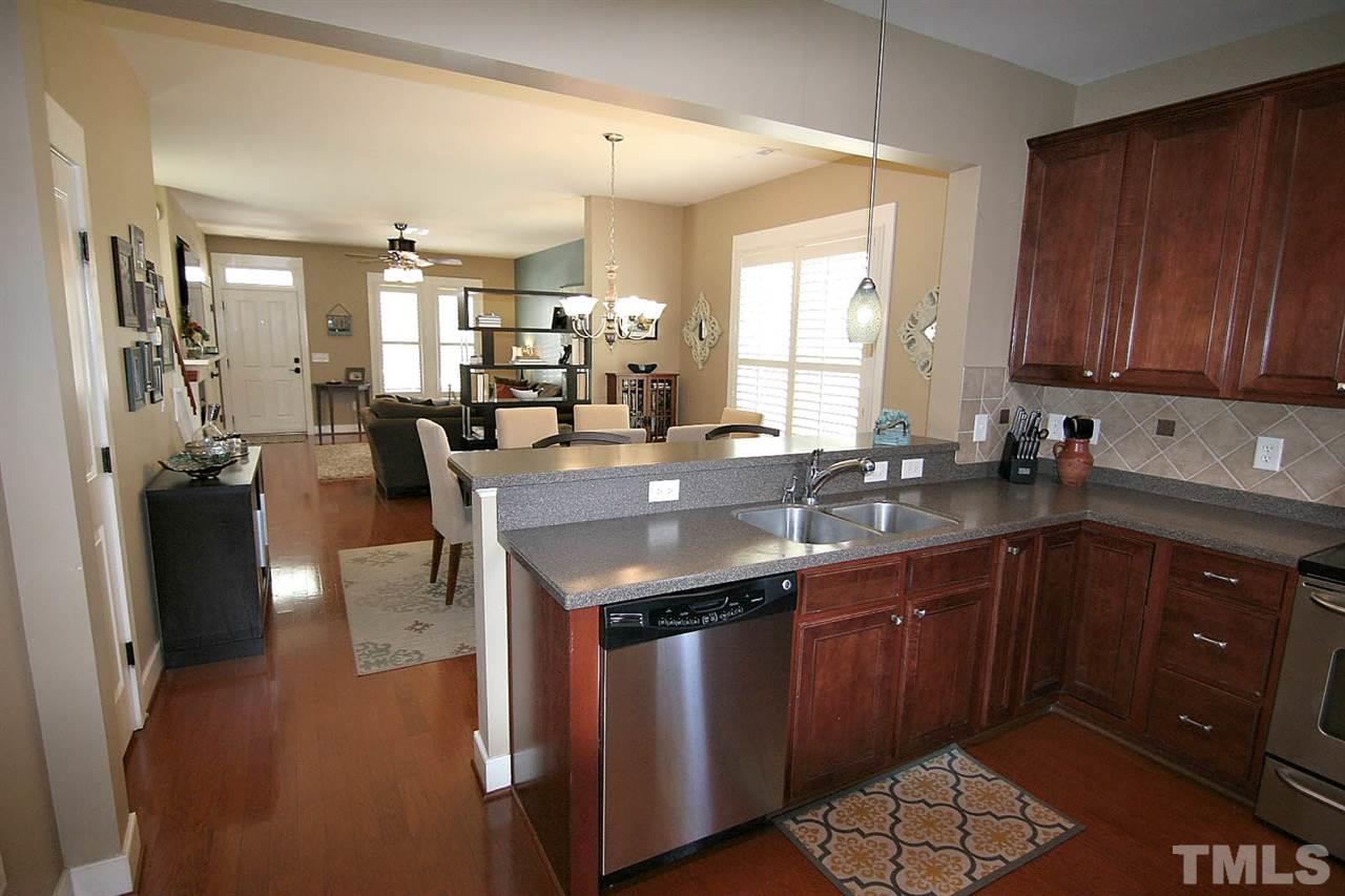 2248 Dunlin Lane Raleigh, NC 27614 - Photo 8 of 24 a kitchen with stainless steel appliances granite countertop a sink stove and cabinets