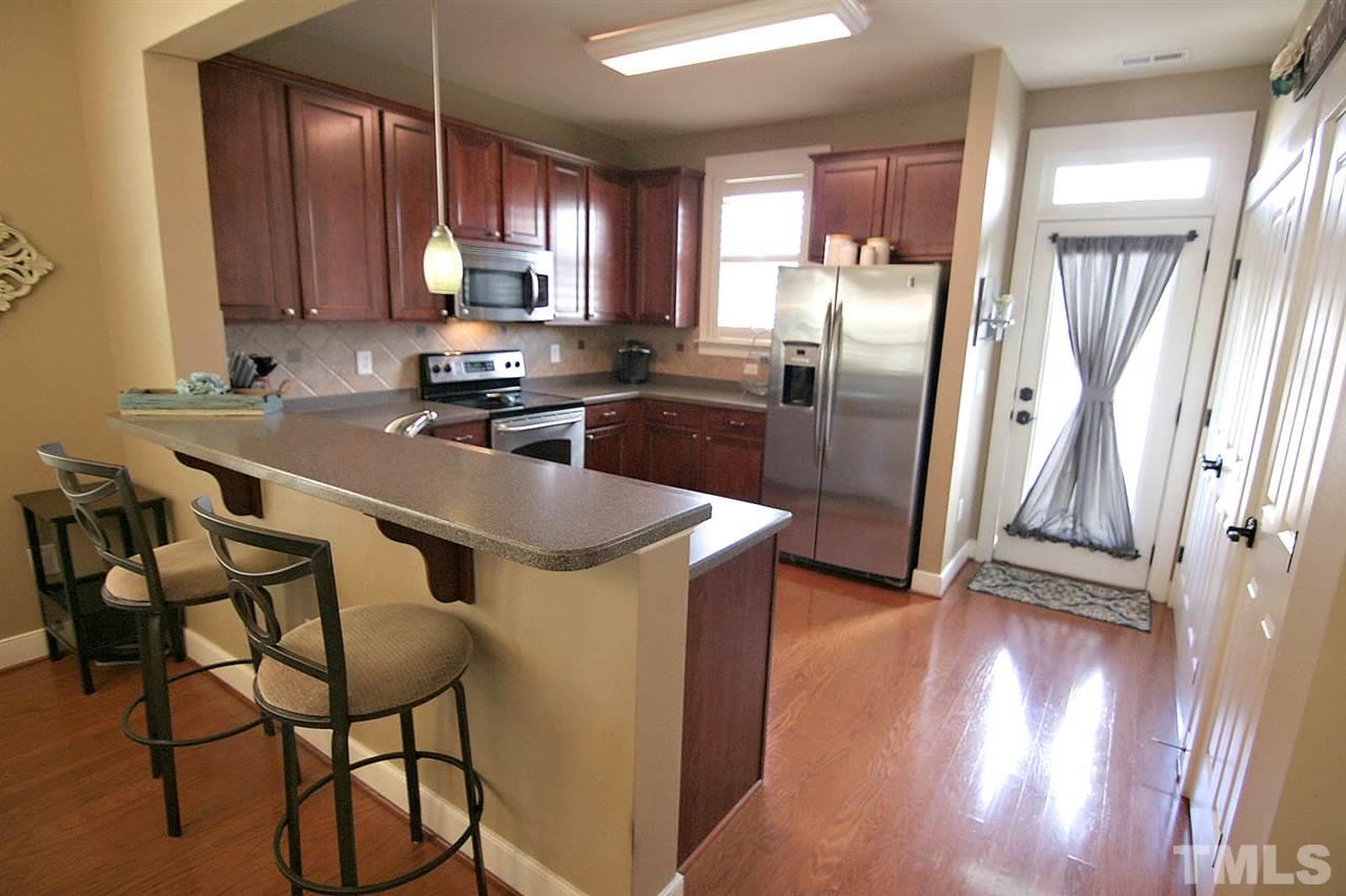 2248 Dunlin Lane Raleigh, NC 27614 - Photo 10 of 24 a kitchen with granite countertop a refrigerator stove and wooden floor