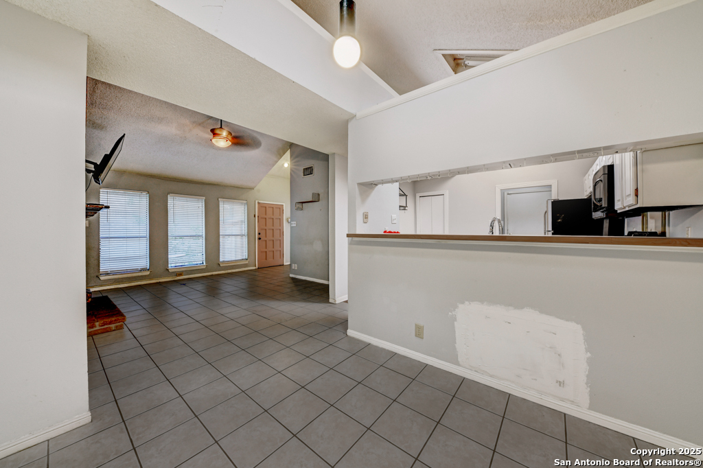 15010 Spring Shower San Antonio, TX 78247 - Photo 14 of 27 a view of a kitchen with furniture and cabinets