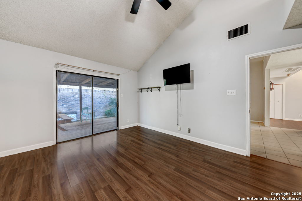15010 Spring Shower San Antonio, TX 78247 - Photo 16 of 27 an empty room with wooden floor and windows